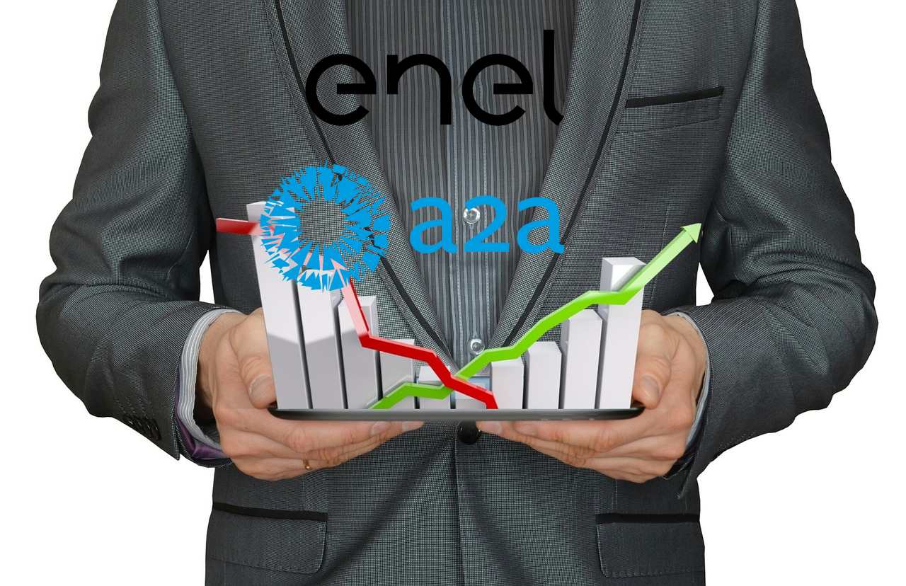 trader con grafici al rialzo e al ribasso e loghi di Enel e A2A