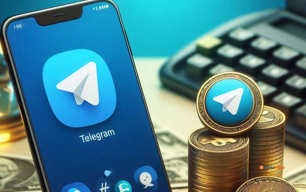 Lo schermo di uno smartphone con il logo di Telegram e delle monete impilate con lo stesso logo su una faccia