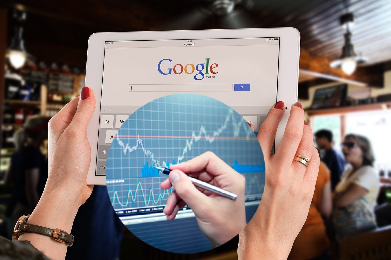 tablet aperto sulla home di Google e grafico di borsa