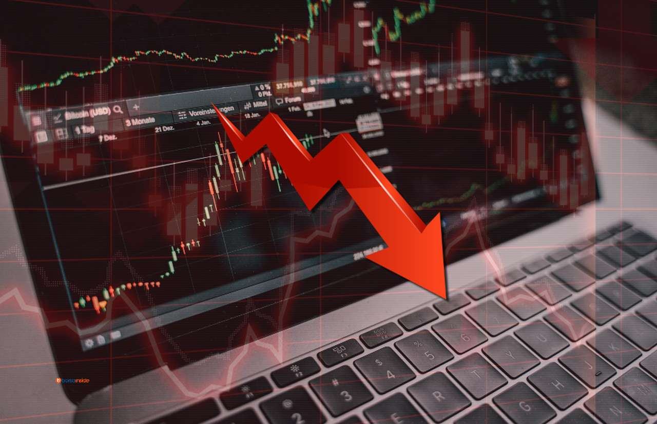 Alcuni grafici finanziari con una freccia rossa diretta verso il basso in sovrimpressione