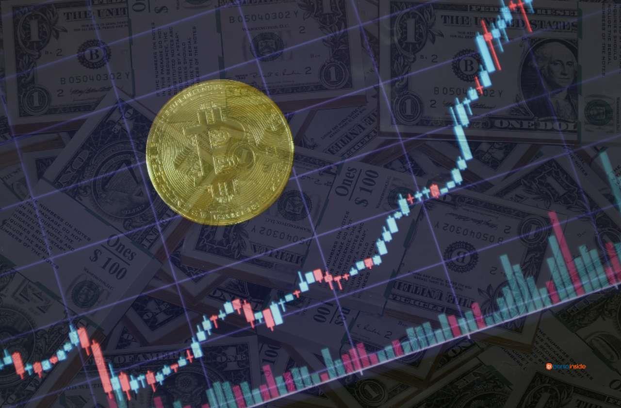 Una moneta di Bitcoin su un grafico a candele