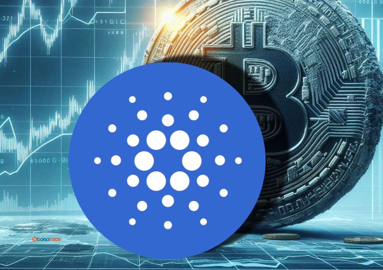 Il logo di Cardano che sovrasta una moneta con il logo di Bitcoin. Sullo sfondo dei grafici finanziari