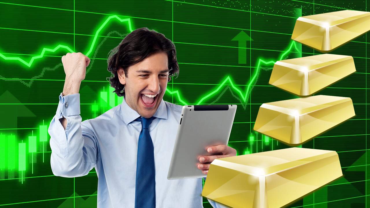 lingotti di oro e trader che esulta