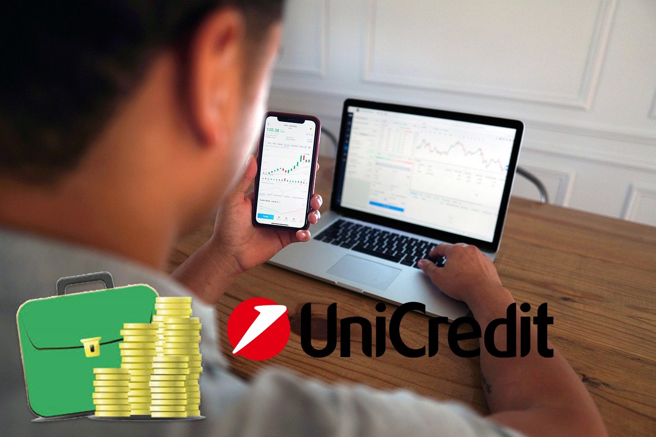 trader in azione e logo di Unicredit